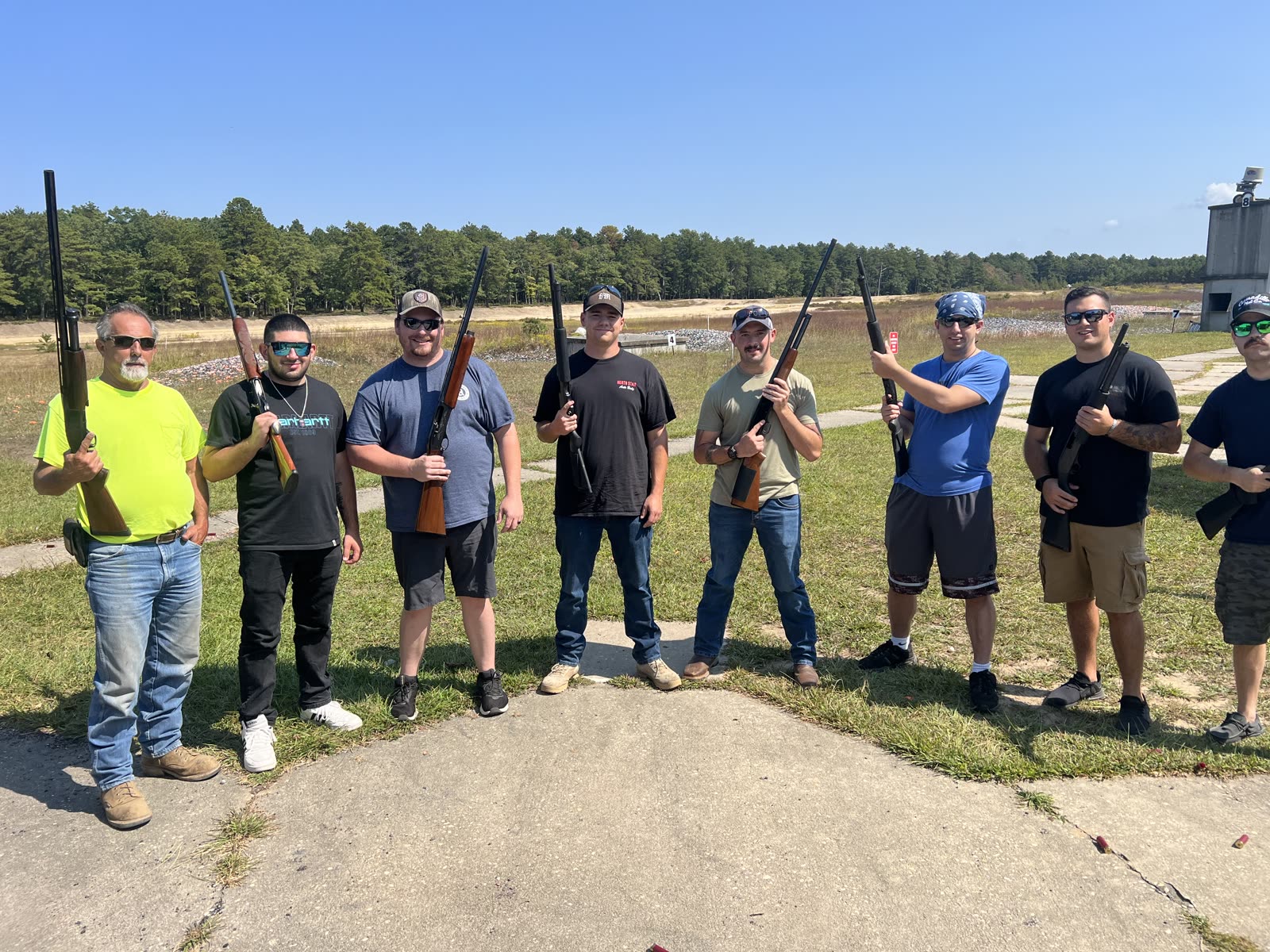 Eight friends on the range, one in a neon yellow shirt