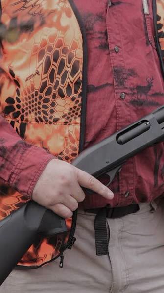 A shotgun held safely across the chest, included for the outing