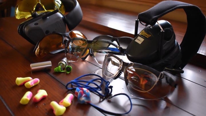 Shooting glasses, ear muffs, and earplugs laid out and ready